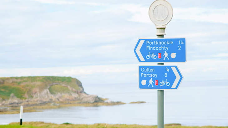 National Cycle Network signage with cliffs in the background on the newly improved Cullen to Portknockie path.