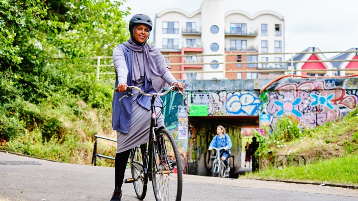 Woman on a bike near to an underpass in Easton, Bristol 