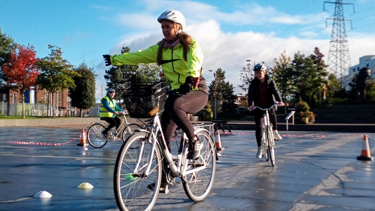 Lord Mayor Kate Nicholl on her bike, practicing hand signals at a cycle training session at CS Lewis Square, Belfast.