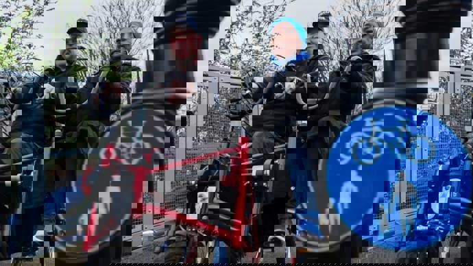 Man and woman using adapted bike on walking and cycling path