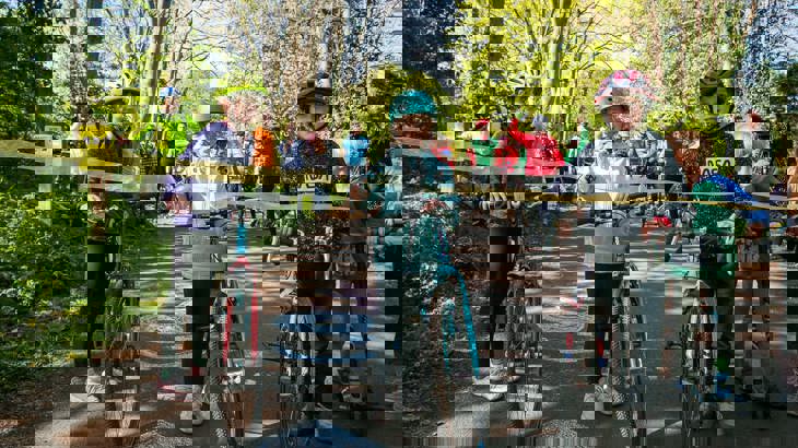 Wylam Waggonway launch event - Image of children with bikes cutting ribbon - spring day - sunny in a crowd under trees