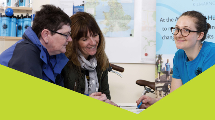 A group of three women happily chatting in Walk Wheel Cycle Trust's Active Travel Hub in Kilmarnock