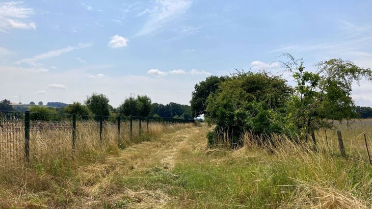 'before' photo of Misbourne Greenway - showing line of route, with fences either side, one to a field and the other to the railway. 