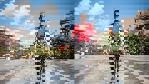 A women cycles through birmingham on a warm sunny day 