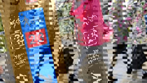 National Cycle Network route sign with two school children walking in background