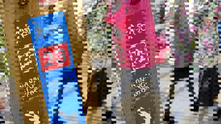 National Cycle Network route sign with two school children walking in background