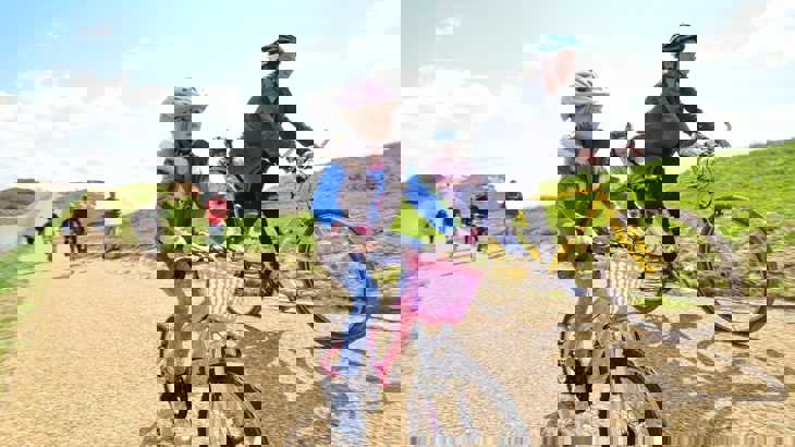 Mother and daughter cycling along a traffic-free National Cycle Network path