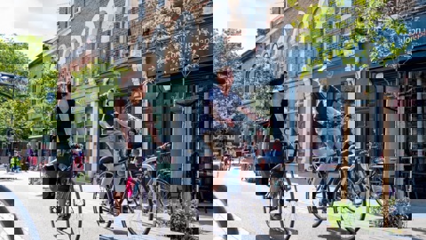 Male and female coworkers cycling side by side