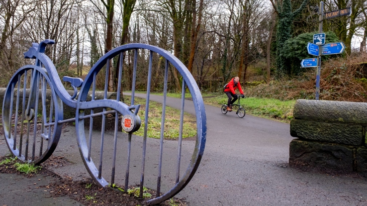 Jon Jewitt is pictured cycling by a sculpture on National Cycle Network route 7