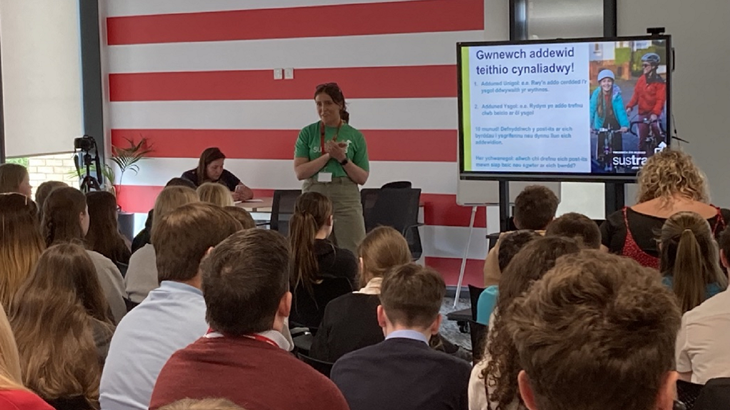 Walk Wheel Cycle Trust colleague presenting to an audience of pupils in Pontypridd at Welsh Youth Parliament event.