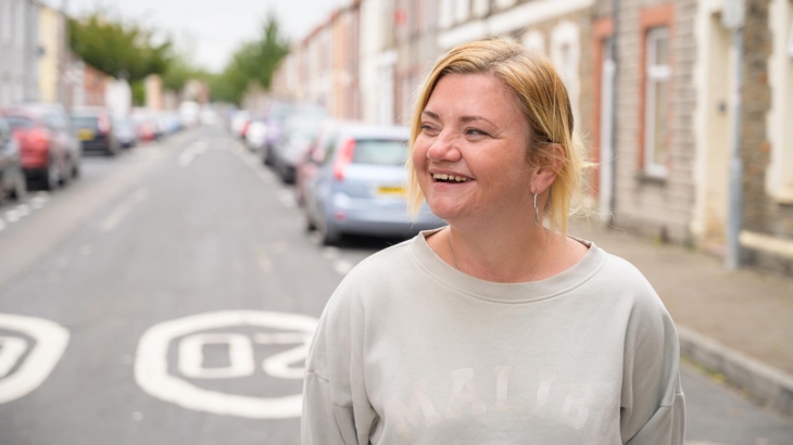 A woman smiling on a residential street where 20mph is already the default speed limit.

Menyw yn gwenu ar stryd preswyl sydd eisoes â therfyn 20mya.