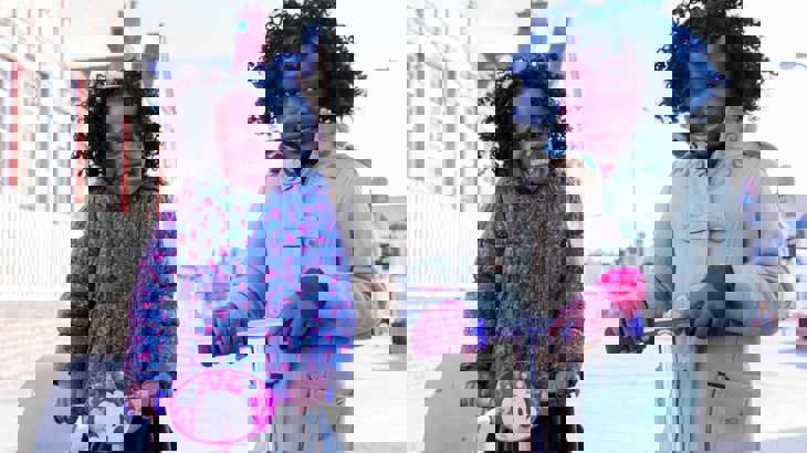 Two girls scooting to school