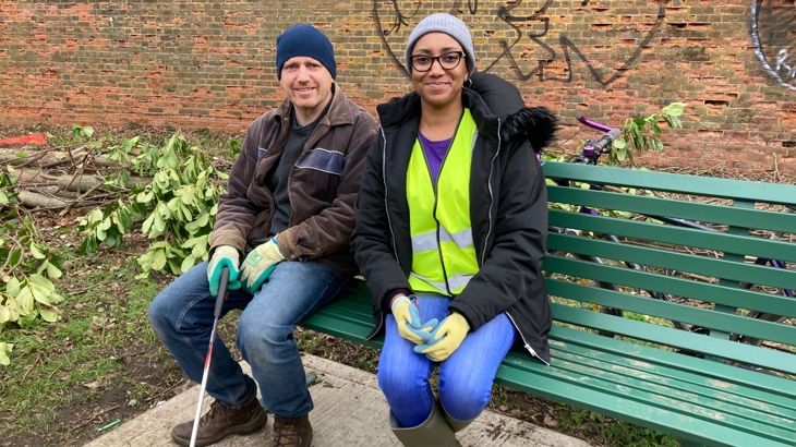 Two ~Walk Wheel Cycle Trust volunteers sitting on a bench smiling.