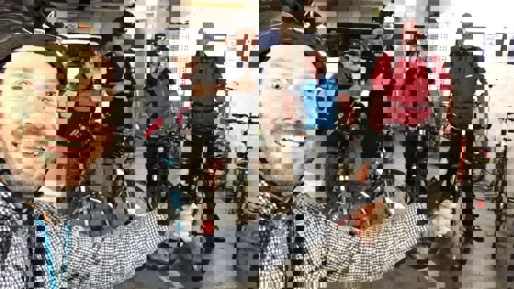 Selfie of Walk Wheel Cycle Trust volunteer, Gordon, with a group of colleagues wearing helmets and posing with their bicycles