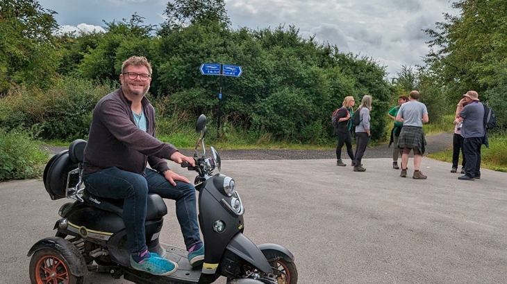 A man sat on his mobility scooter smiling on a section of the Network in Doncaster
