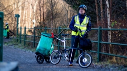 Michael litter picking with his Brompton on National Cycle Network Route 7 in Renfrewshire alongside the Thursday Squad.