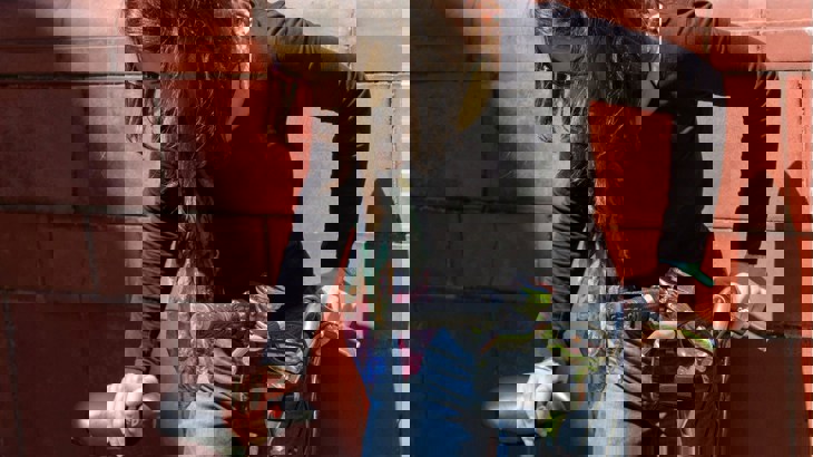 Woman checking saddle and handlebars on bike