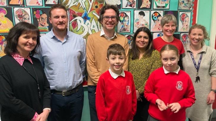 Colleagues from Walk Wheel Cycle Trust and the Department for Infrastructure pictured with staff and pupils from Holy Family Primary School in Belfast.