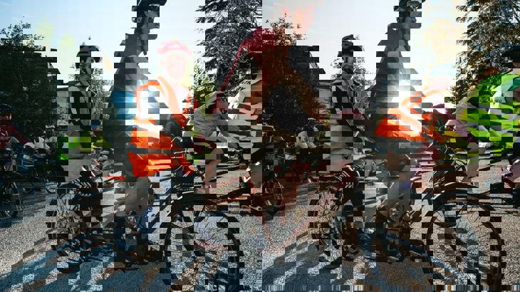 person with a disabilty riding on the back of a tamdem