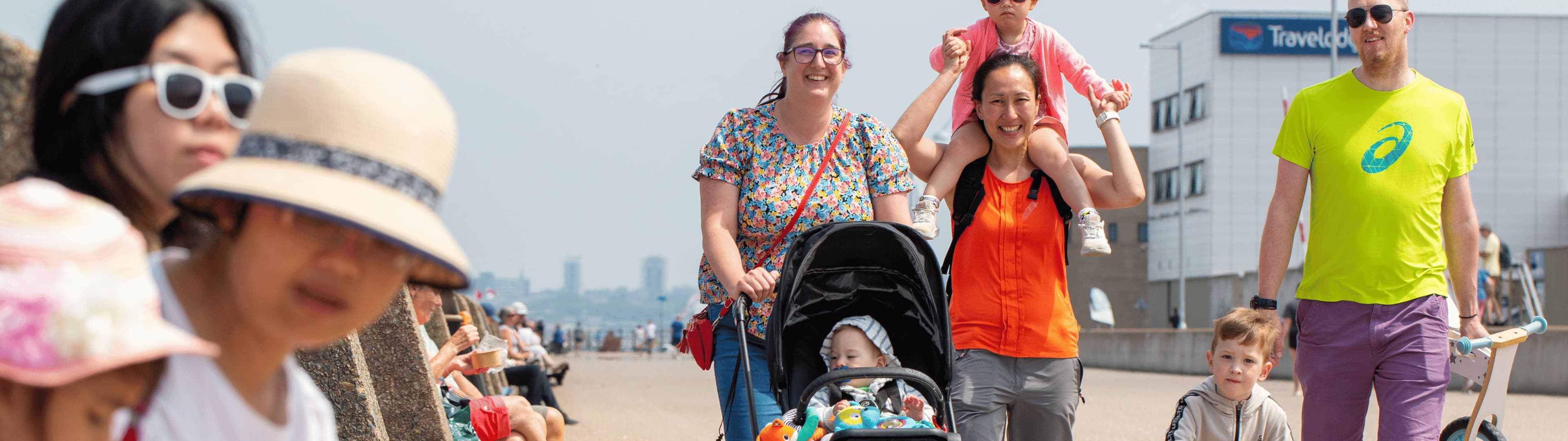 Family walking along beach front.
