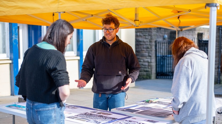 A Walk Wheel Cycle Trust colleague discusses the Wick Lanes Pocket Places project with residents at an event to mark completion.