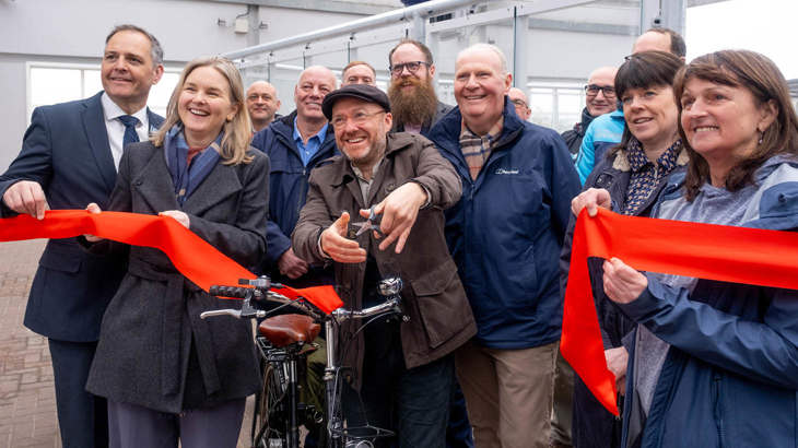 A group of people including Walk Wheel Cycle Trust in Scotland Director Karen McGregor and Patrick Harvie MSP cut a red ribbon to open the Gourock project