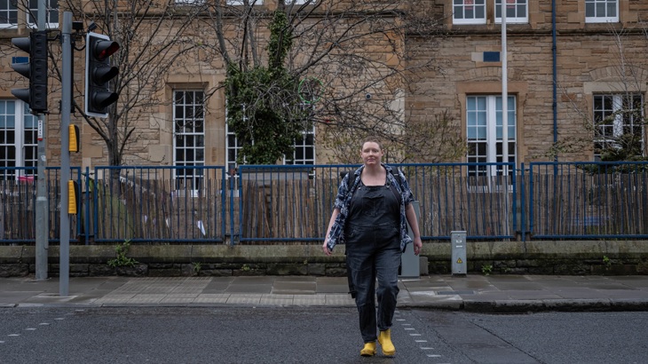 A person is shown crossing the road in Edinburgh