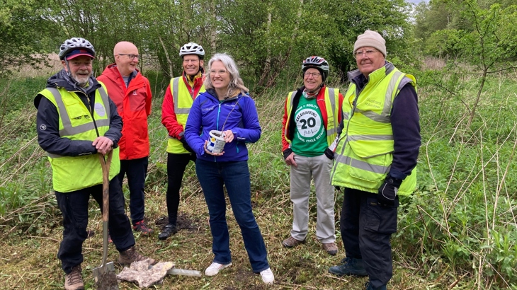 Walk Wheel Cycle Trust volunteers and Walk Wheel Cycle Trust in Wales Director, Christine Boston, standing with a commemorative tree to mark the occasion of 20 years of volunteering