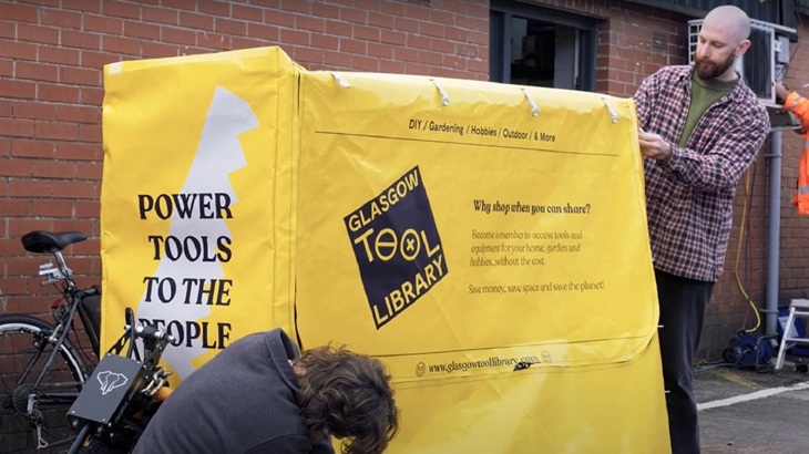 The Glasgow Tool Library team are shown preparing the e-bike trailer for a delivery.