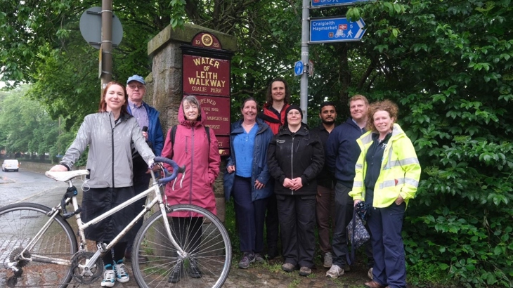 Supporters, councillors and partners in front of the newly refurbished Water of Leith signs at Coalie Park as community celebrates project launch.