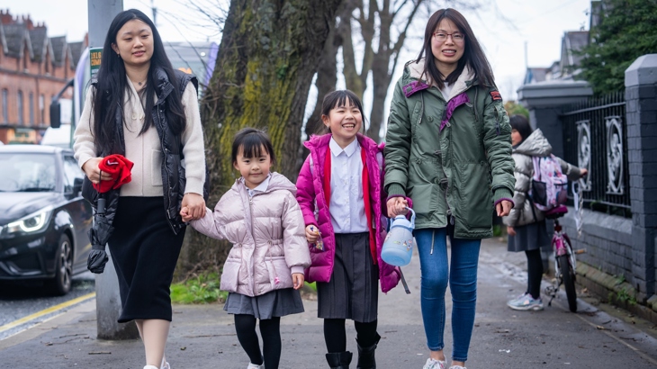 Parents walking children home from school on Falls Road, west Belfast.