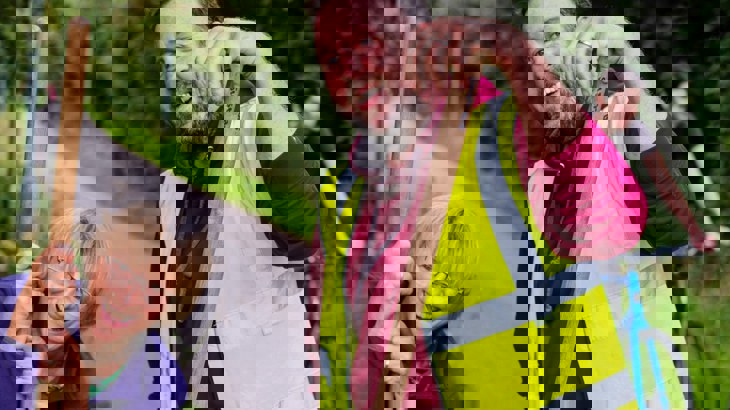 Two volunteers smiling on the NCN with brushes