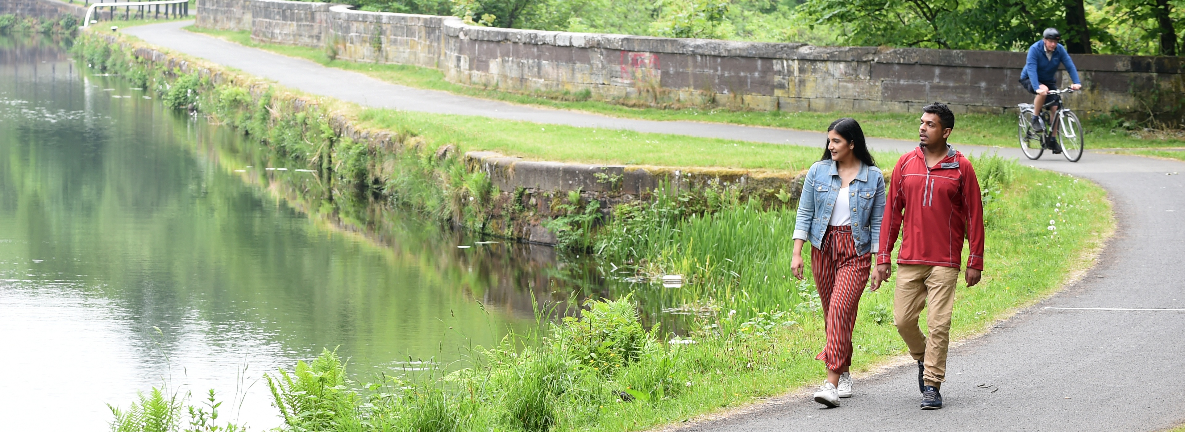 A couple walking alongside Maryhill Locks, Glasgow