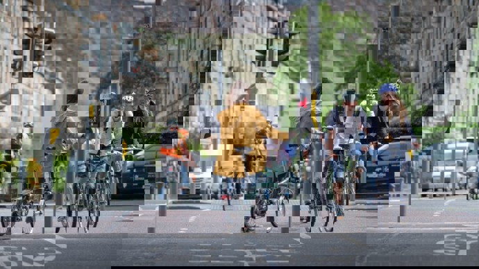 A Woman Standing At Some Traffic Lights In Edinburgh