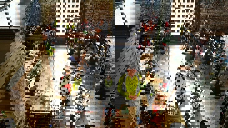 Cycle friendly cafe with man ordering a coffee at counter