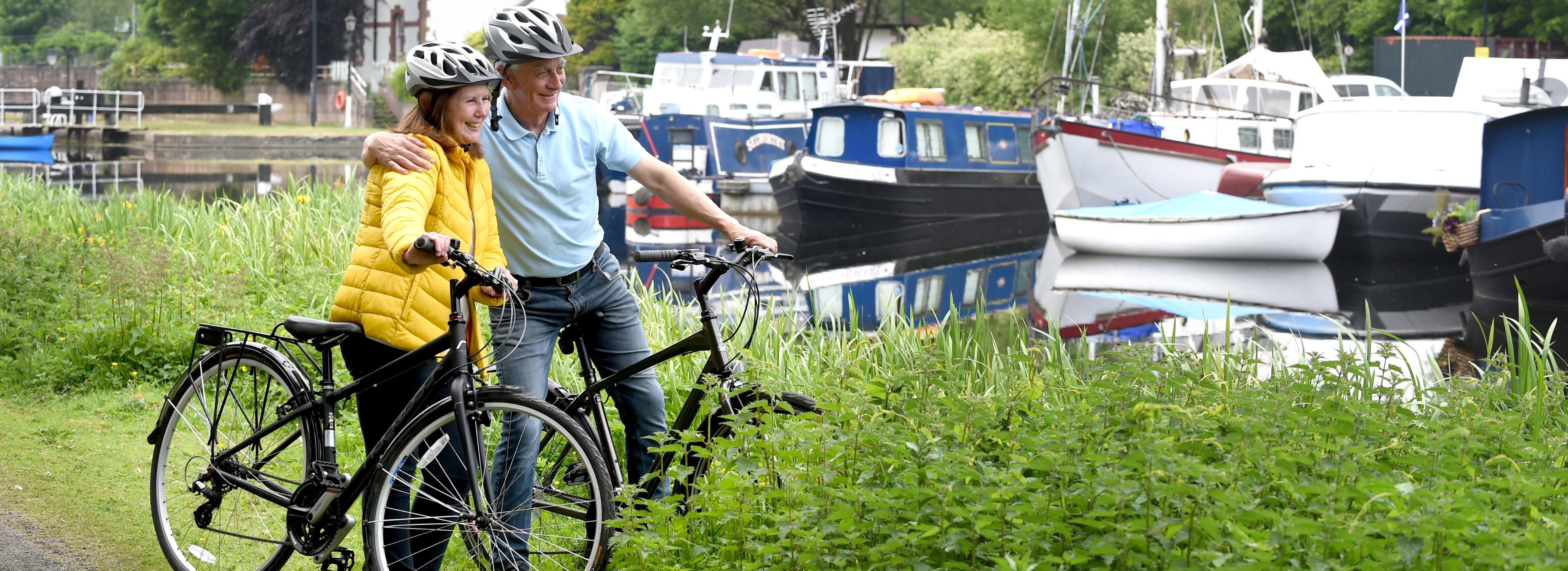 Older couple with bikes next to canal