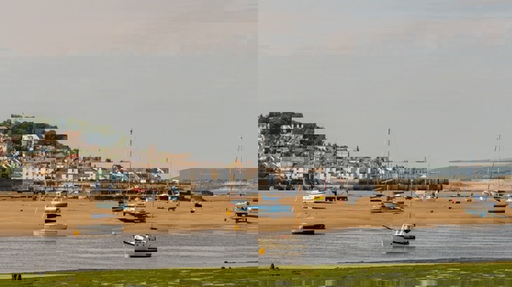 Yachts and boats in harbour of Devon town with the tide out