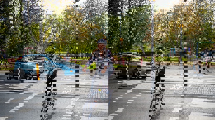Woman cycling over a road crossing in London