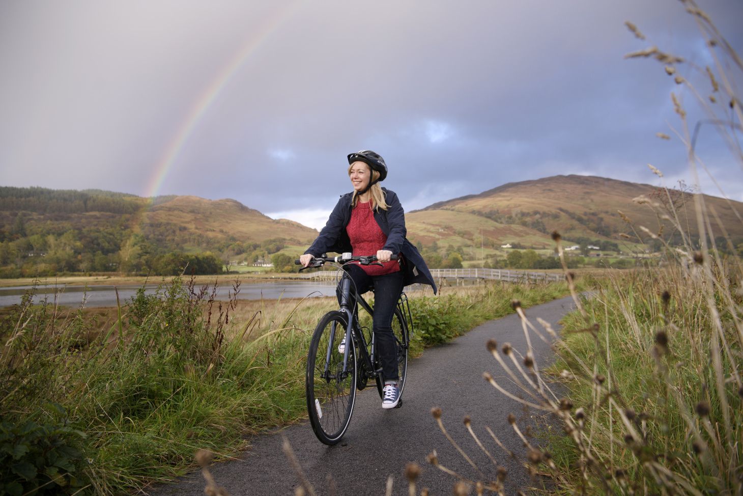 Lady cyclist with Rainbow