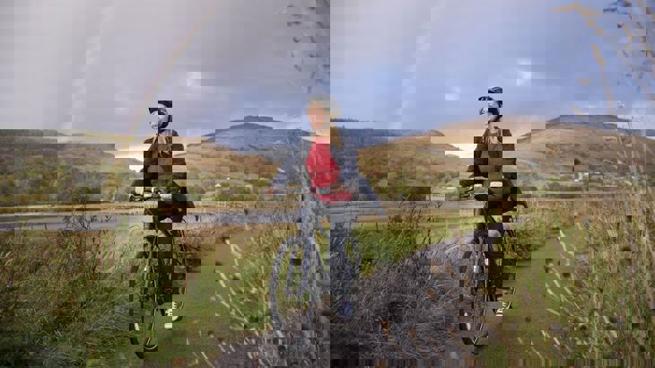 Lady cyclist with Rainbow