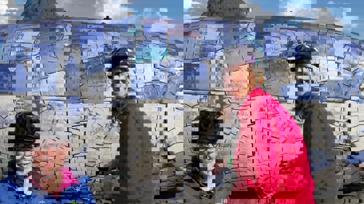 Two people from LORAG’s Wheely Inclusive Cycling Project stopping at The Big Fish on a Walk Wheel Cycle Trust led ride