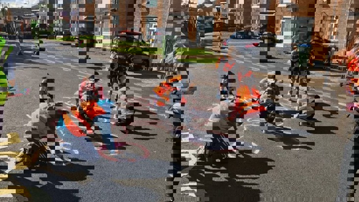 Pupils drawing on the streets to make them cycle friendly