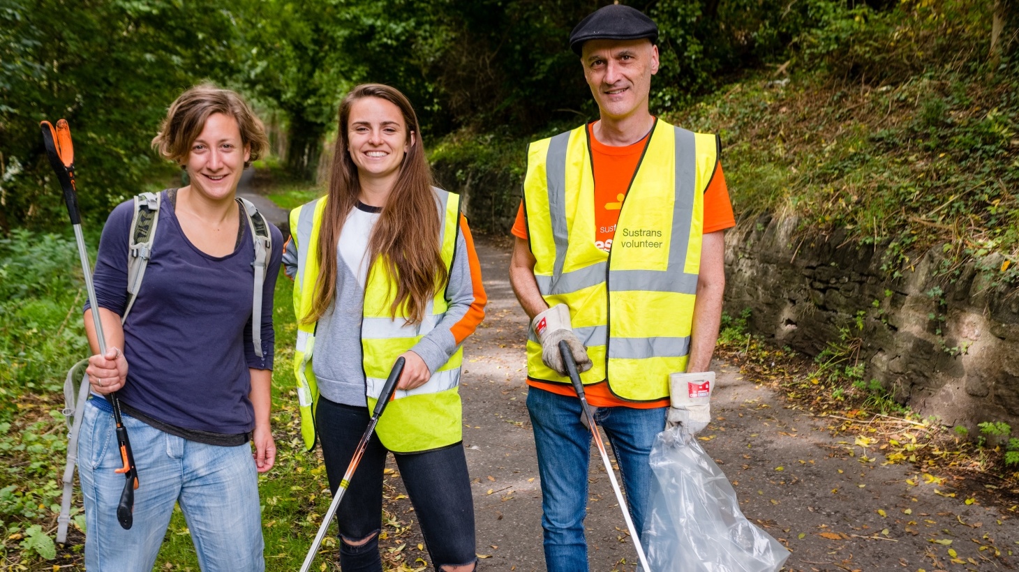 Three volunteers litter picking on the National Cycle Network