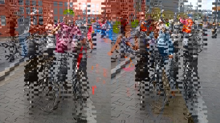 Members of the public at Cycle on the Snedd posing with 20 pound notes