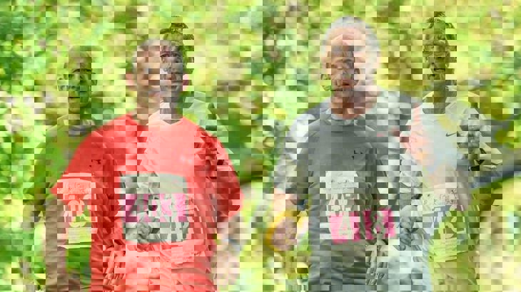 Two men in running race with runner number stickers on their shirts