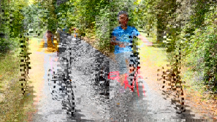 An adapted bicycle and a push  bike ride along a traffic-free path