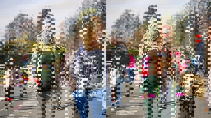 A mother walks with her daughter to school 