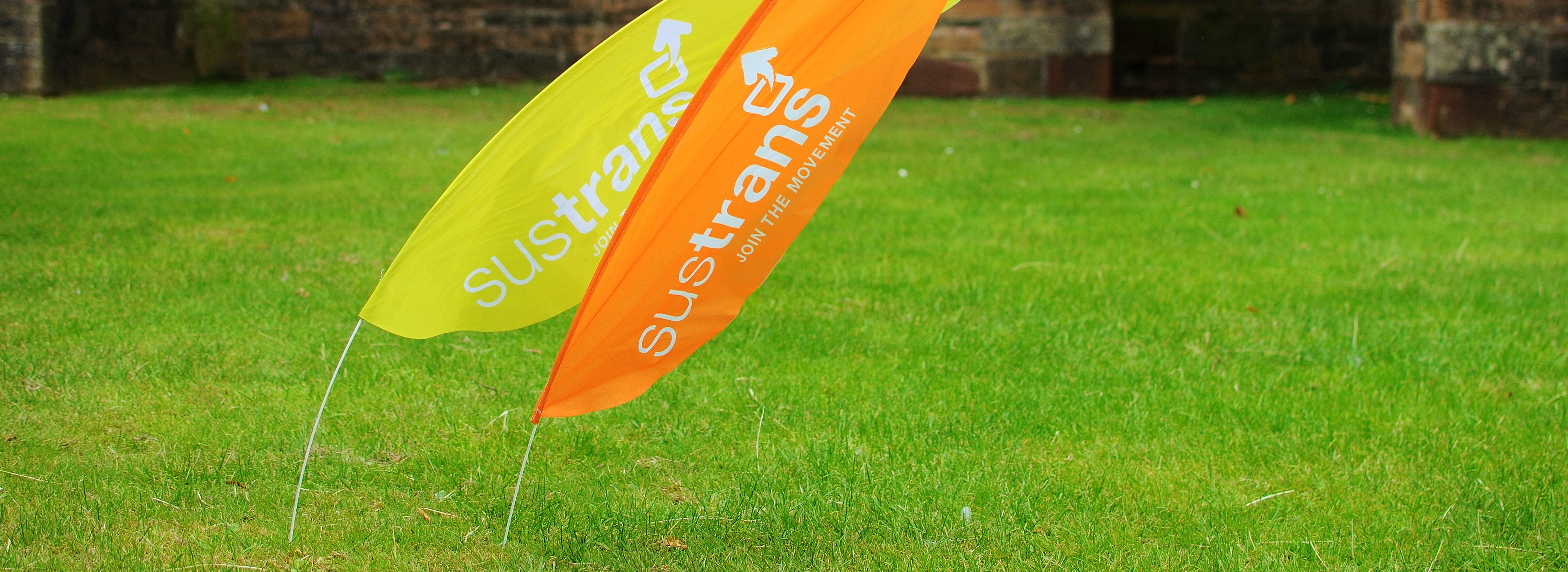 Walk Wheel Cycle Trust flags on green grass