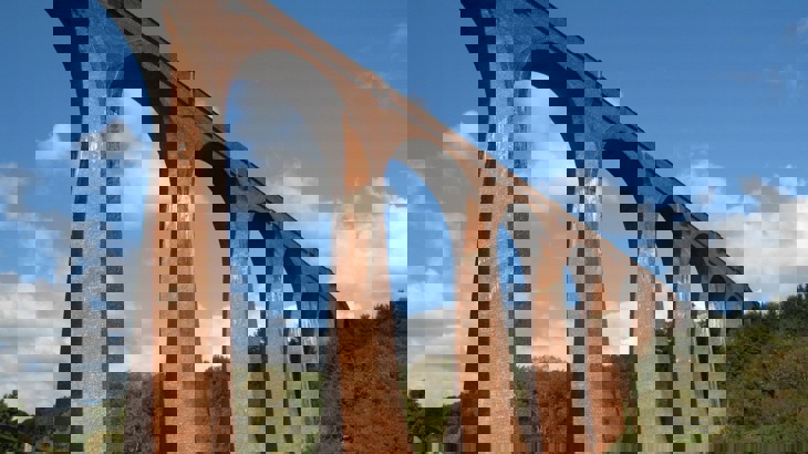 A tall red brick railway viaduct