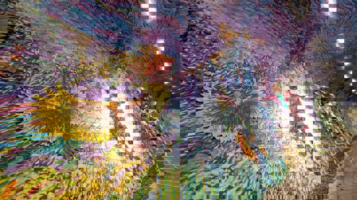 Artist Chris Rutterford painting at the Colinton Tunnel, NCN 75. ArtRoots has supported the Colinton Tunnel project with funding.